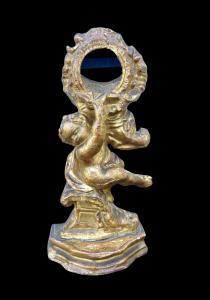Clock holder in carved wood and gold leaf depicting a child with rocaille elements.