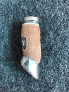 Metal matchbox in the shape of a deer's paw covered in leather. Dlponirt brand. England.