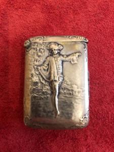 Silver matchbox without hallmark, decorated with a male figure and architectural elements.
