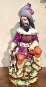 Porcelain veilleuse night light-teapot featuring a male figure in costume with a dog. Jacob Petit model, France.
