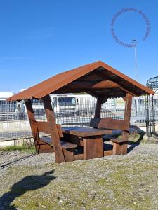 Wooden gazebo with table and benches