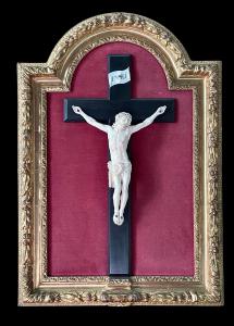 Ivory Christ on ebony cross, with gold leaf shaped frame.