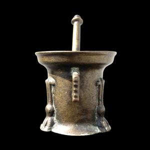 Bronze mortar with side handle and three lion feet.