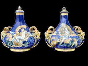 Pair of majolica flasks with historical decoration and handles in the shape of masks. Battaglia manufactory. Naples.