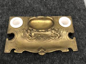 Empire period bronze inkwell with fighting angels and rocaille motifs.