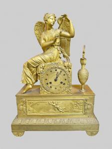 Gilt bronze table clock with winged figure, France early 19th century.