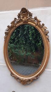 Antique gilded oval mirror with crest