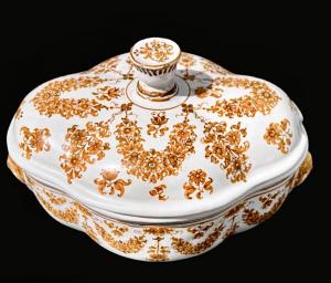 Maiolica tureen decorated with floral motifs and festoons with mask-shaped handles in ochre monochrome. Moustiers, France. Signature Jean Etienne Baron. Olerys and Laugier manufacture.