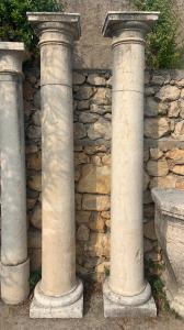 Pair of antique bush-hammered white marble columns