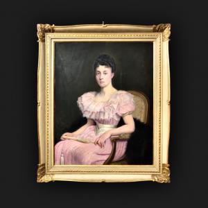 Pintura a óleo sobre tela representando uma figura feminina sentada com um leque. França. Assinatura: D'après L. Galauac 1894.