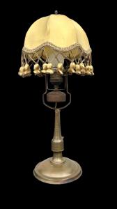 Bronze lamp with tapered stem and round base. Art Nouveau period.