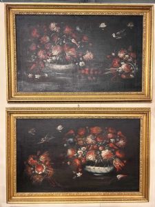 Pair of 17th-century still lifes with vases of flowers and birds.