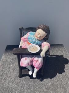 Tobacco box depicting a sleeping child in a high chair. France.