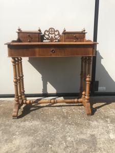 Light walnut writing desk with drawer and 4 small drawers. Sliding top.