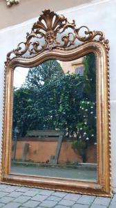 Antique gilded wood mirror with fretworked crest and silvered mirror