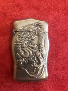 Silver matchbox with dragon decoration on both sides, no hallmarks.