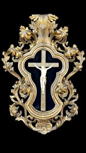 Ivory Christ with carved wooden scroll frame and gold leaf.