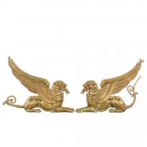 Pair of gilt bronze winged lion fire dogs. France, early 19th century.