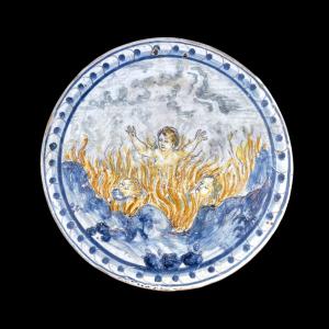 Formella tonda in maiolica decorata con motivo istoriato ‘ peccatori all’inferno’.Manifattura di Francesco Vicchi.Faenza.