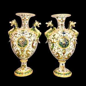 Pair of majolica vases with dragon-shaped handles, decorated in Raphael style and with noble coats of arms. Minghetti manufacture, Bologna.