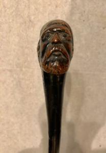 One-piece wooden cane depicting an Arab man.
