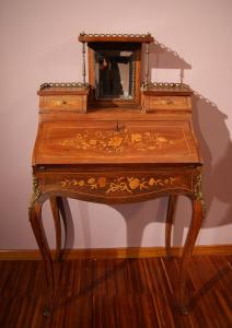 Antique French fall-front desk from the 1800s with a Louis XV style raised section, richly inlaid.