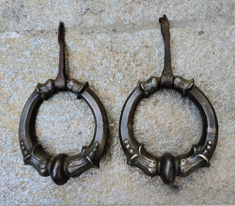 Pair of cast and chiseled bronze ring knockers