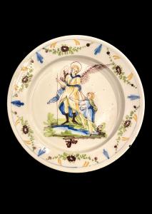 Majolica plate with festoon and floral motif decorated border and well scene depicting 'Archangel Raphael and Tobias'. Pavia.