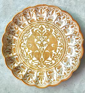 Piatto- crespina baccellato,decorato a lustro con animali fantastici nell’umbone e motivi geometrici sulla tesa .Manifattura Grazia,Deruta.