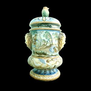 Majolica vase with lid, vegetal-shaped grip, and lateral masks. Historicized decoration. G.Cristin manufacture, Naples.