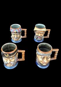 Serie di 4 boccali in grès a forma di teste di personaggi.firma S.Orvis Capodimonte.