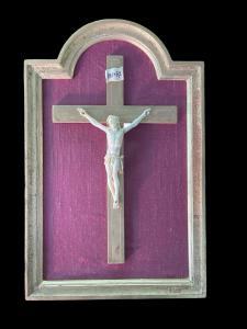 Ivory Christ on cross within gilded frame.