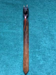 Wooden letter opener carved from a single piece representing a devil's head.