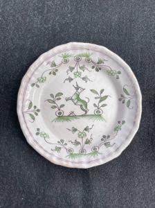 Majolica plate with stylized animal and plant decoration. Bordeaux, France.