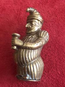 Brass matchbox depicting a hunchbacked jester.