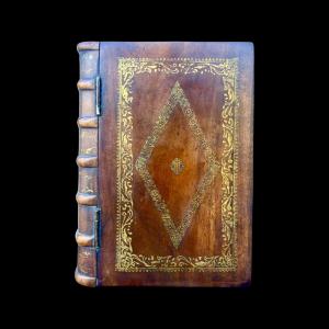 Mahogany box shaped like a book with gold engravings. England.