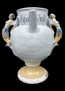  Grande versatoio in maiolica da farmacia con prese a forma di angeli che sovrastano scudi con iniziali.Manifattura Casali e Callegari.Pesaro,epoca’700