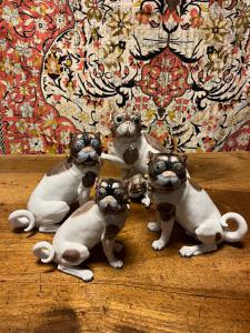 Pair of Dresden porcelain dogs, rich in detail with pink collars and gilded capelin. Single dog with puppy. Can be sold separately.
