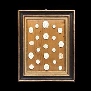 Group of stuccos derived from antique carvings and cameos with profiles of emperors and neoclassical subjects within a frame.