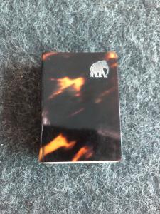 Tortoiseshell matchbox with a small silver shield in the shape of an elephant.