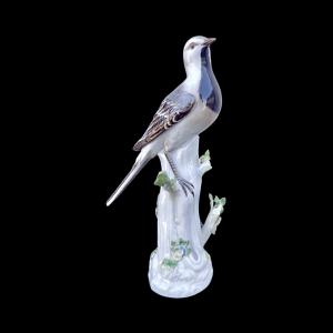 Scultura raffigurante uccellino su ramo fiorito.Meissen.Germania.
