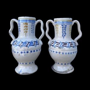 Pair of majolica vases with ribbon-shaped side handles and stylized geometric decorations. Grottaglie manufacture. Puglia.