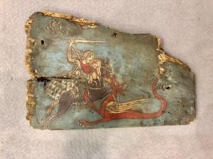 Painted wooden panel of a Sicilian cart with a scene depicting Saint George and the Dragon.