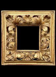 Carved and gilded wooden frame.