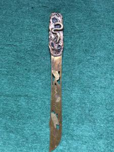 Openwork brass letter opener decorated with a snake figure and stylized plant motifs. Japan.