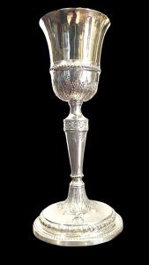 Embossed silver chalice with plant-based motifs.