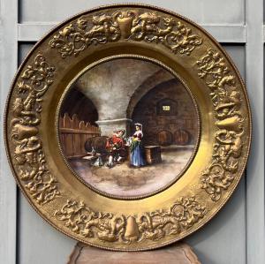 Ceramic plate within a frame in embossed gilded copper