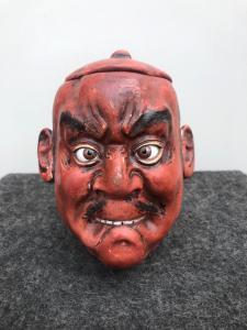 Scatola tabacchiera in papier mache’ raffigurante testa giapponese.