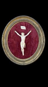 Ivory Christ on oval frame in wood and gold leaf.