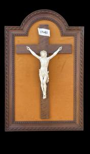 Ivory Christ on carved wooden frame.